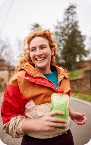 Walks and marathons how can running improve everyday life young woman running smiling holding Nutrino Lab Fitness ready