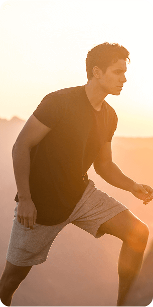 Walks and marathons young man hiking in nature at sunset